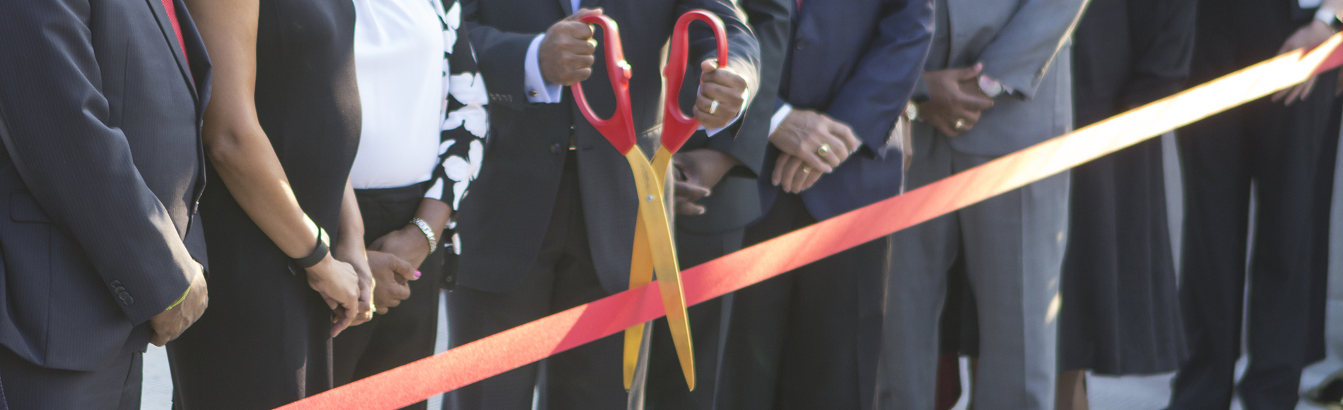 Chancellor Elwood Robinson cutting ribbon at ceremony