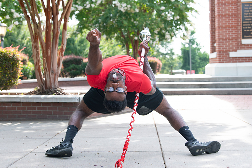 Drum major performs a bend maneuver 