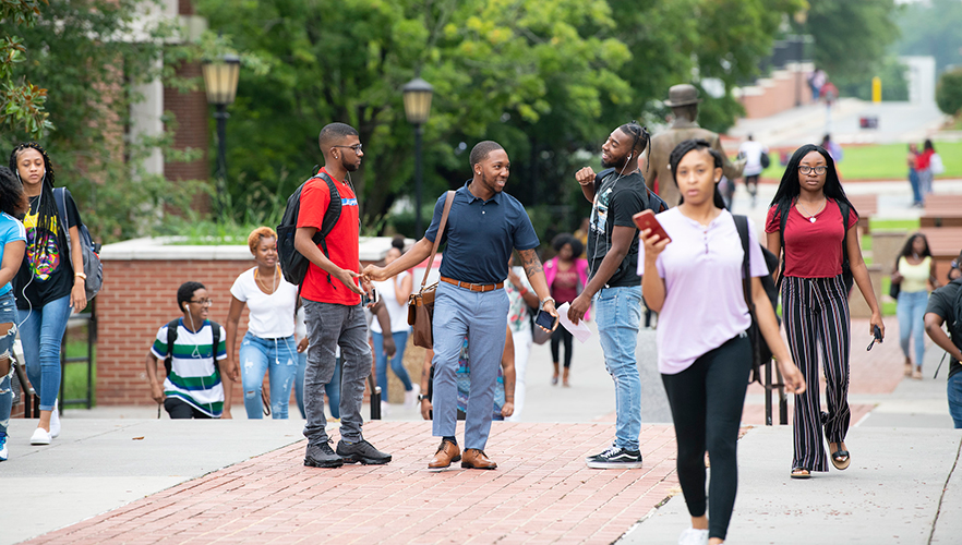 Students on campus in the walkway near C.G. O'Kelly Library