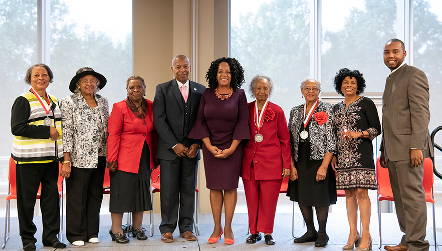 Group photo of honorees and speaker at the Healthcare Legends of East Winston event