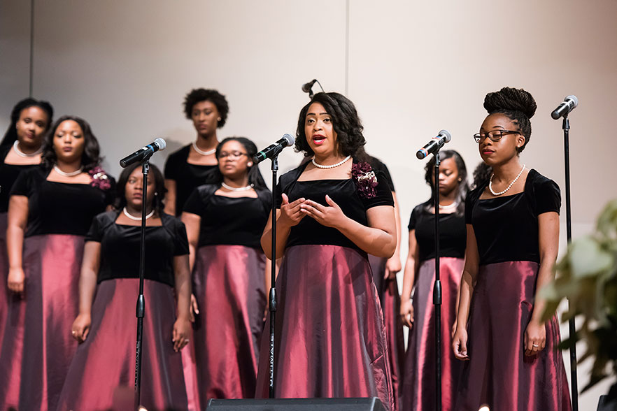 Singing Divas perform on stage at K.R. Williams Auditorium 