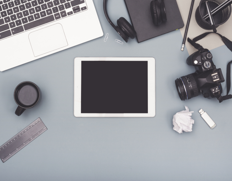 various tech devices laid out on a desk