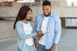 a woman giving a survey to a man