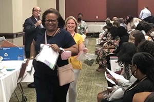 People participate in a recent reentry simulation; Assistant U.S. Attorney Rob Lang is seen with microphone in hand.  REBECCA SAUTER, provided